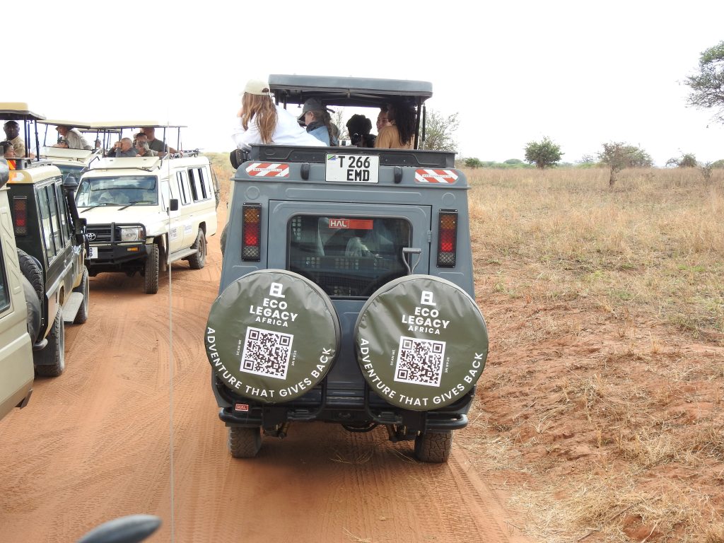 An Ecolegacy Africa safari vehicle with guests at a sighting